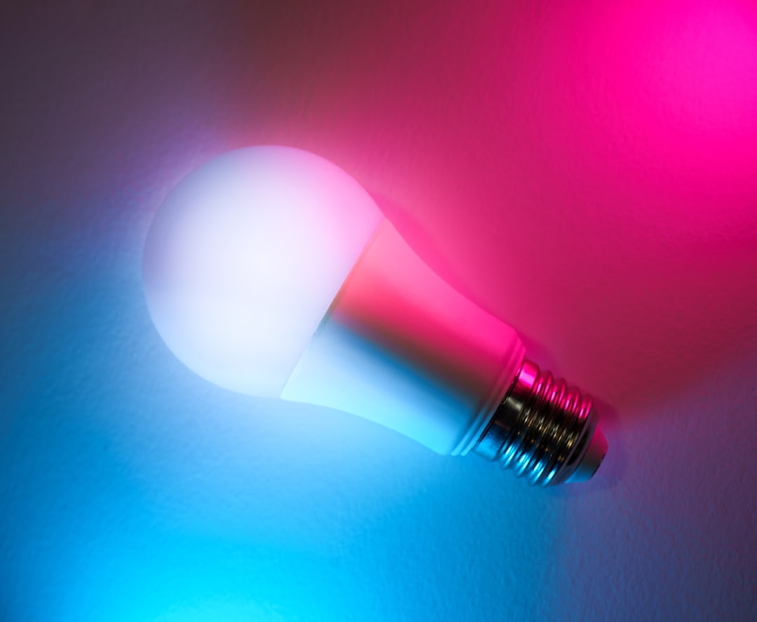 A close up of a pink and blue light bulb