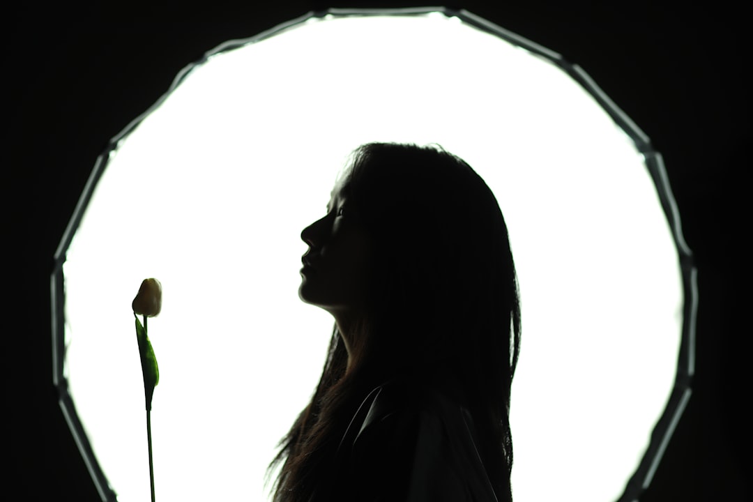 A woman standing in front of a circular light