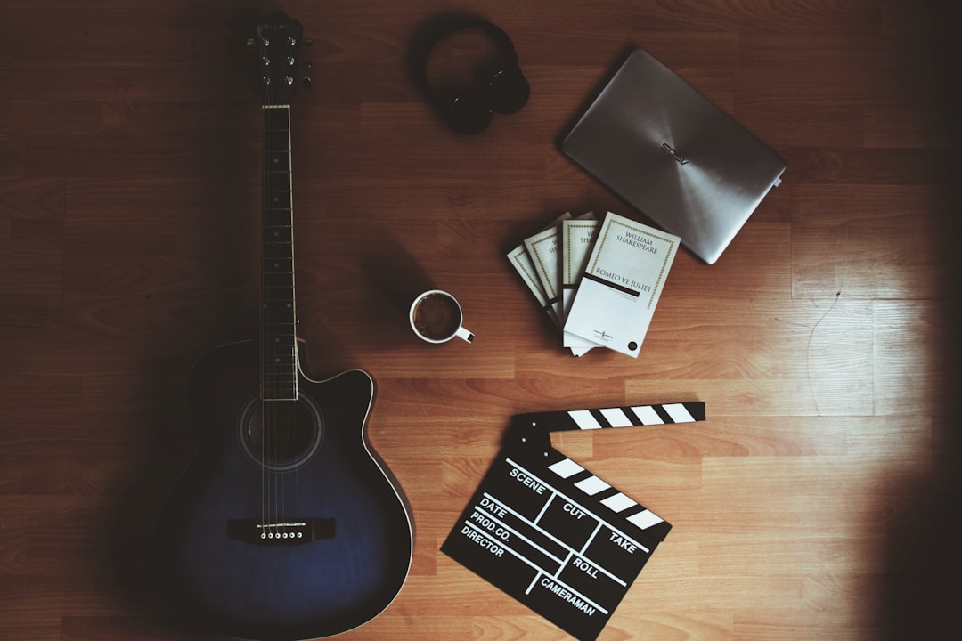 black acoustic guitar on black and white checkered textile