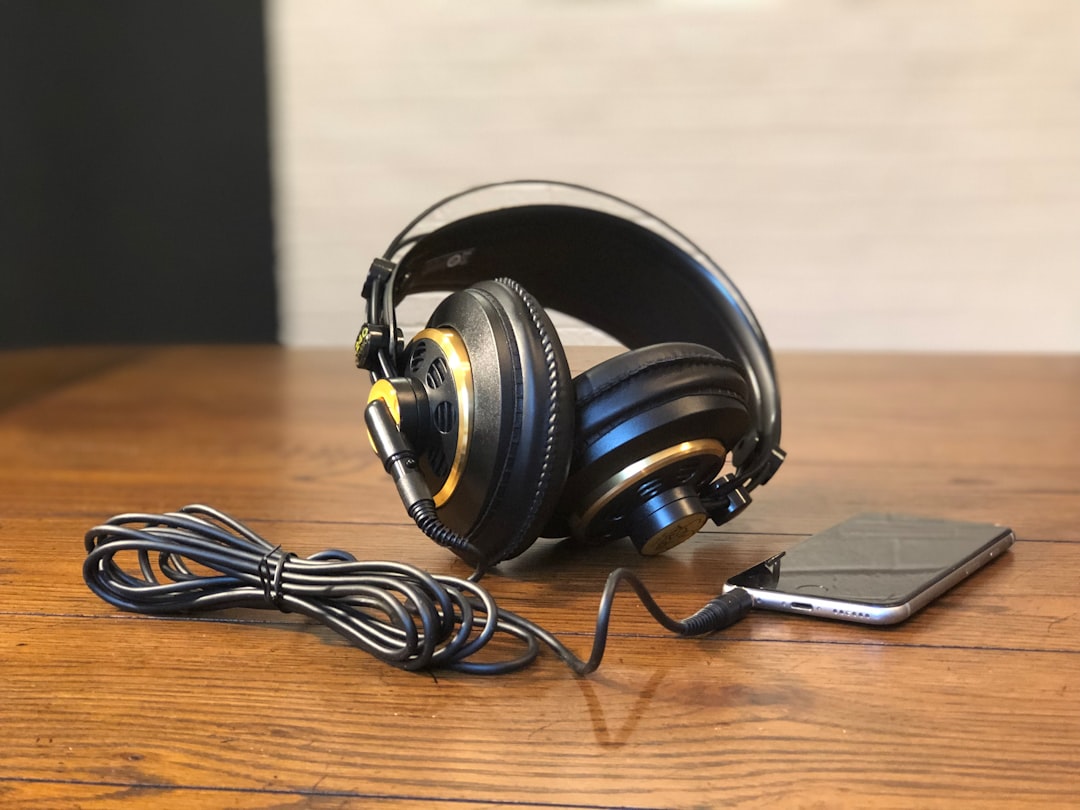 a pair of headphones sitting on top of a wooden table