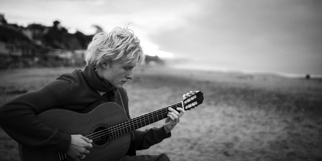Person playing guitar on a beach