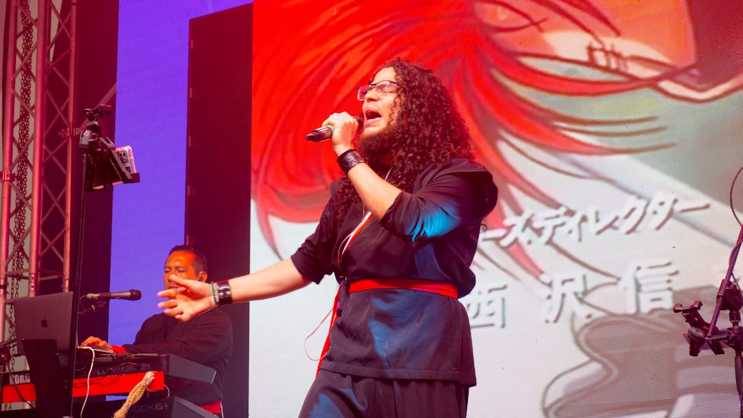 Singer performing on stage with animated background