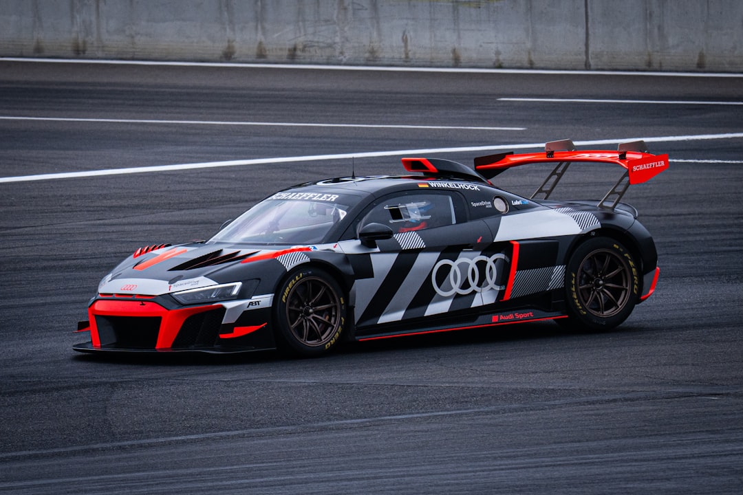 A sleek audi race car speeds along the track.