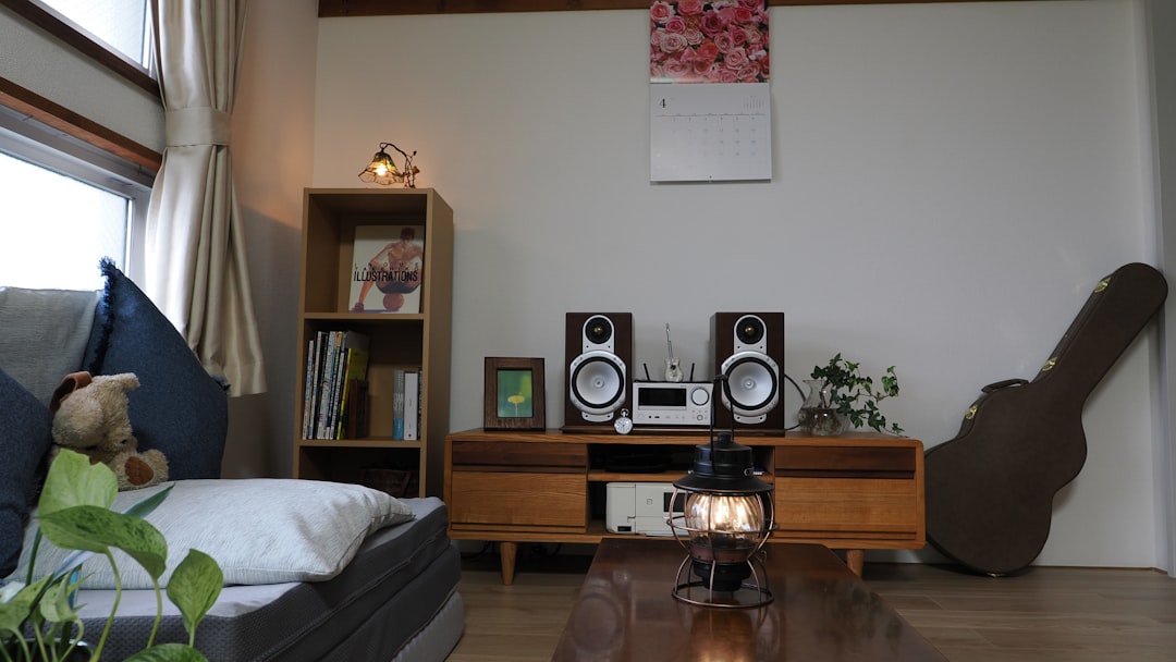 a living room filled with furniture and a guitar